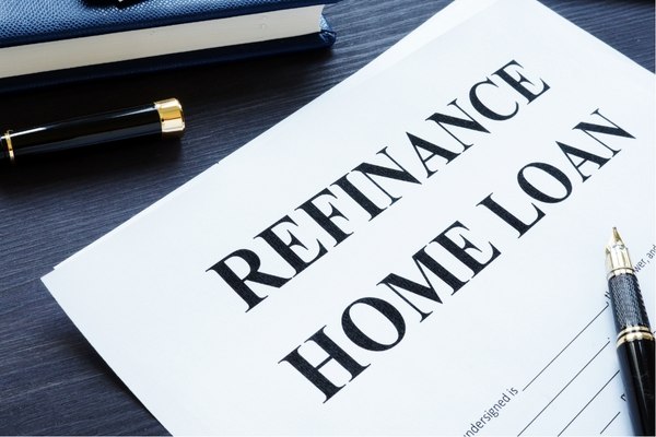 Home loan refinancing application form on table with pen and notebook